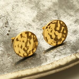 gold hammered disc stud earrings on terracotta