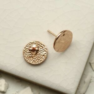 rose gold hammered disc stud earrings taken apart on tile