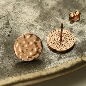 rose gold hammered disc stud earrings taken apart on terracotta