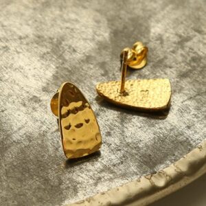 gold hammered triangle studs on terracotta