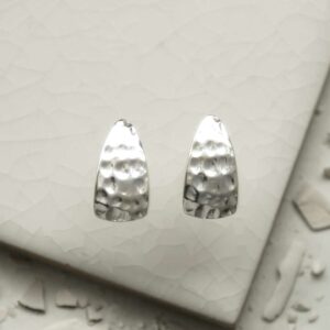 silver hammered triangle studs on tile