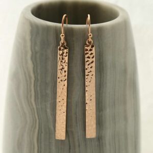 rose gold dangly straight earrings hanging out a pot