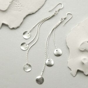 silver discs on long chains earrings strewn