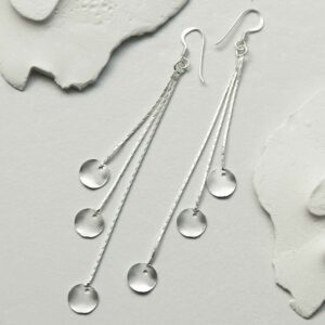 silver discs on long chains earrings laid straight