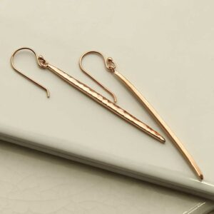 Rose Gold Icicle Dangly Earrings on tile background