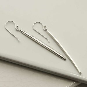 Silver Icicle Dangly Earrings on tile background