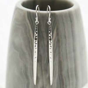 Silver Icicle Dangly Earrings hanging on grey prop