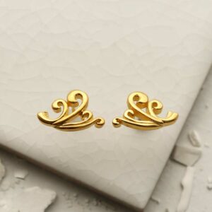 Gold Wave Studs on white tile background