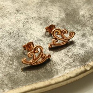 Rose Gold Wave Studs on grey textured background