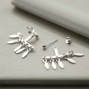 Chandelier Studs on white curved background with one earring undone to show different parts