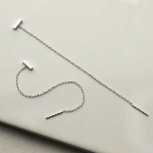 silver tiny bar on chain threader earrings strewn and laid out