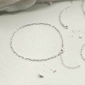 silver thinly linked paperclip anklet laid in circle