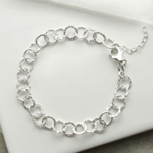 silver hammered link bracelet laid in circle