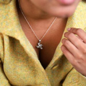 Model In Green Jacket Wearing Sterling Silver Hummingbird Necklace