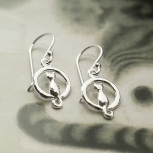 silver cat and full moon earrings laid straight