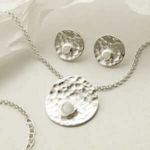 single moonstone gems in centre of hammered necklace and earrings