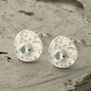 single blue topaz gem in centre of hammered stud earrings