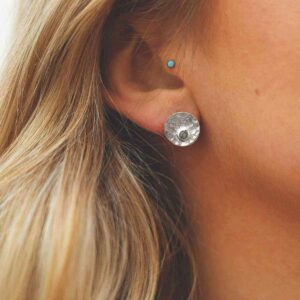 single labradorite gem in centre of hammered stud earrings on model