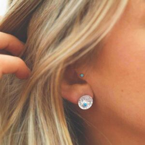 single opalite gem in centre of hammered stud earrings on model