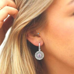 single amethyst gem in centre of chrysanthemum earrings on model