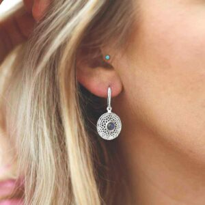 single labradorite gem in centre of chrysanthemum earrings on model