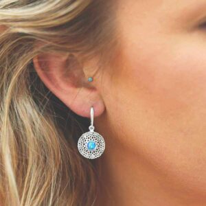 single opalite gem in centre of chrysanthemum earrings on model