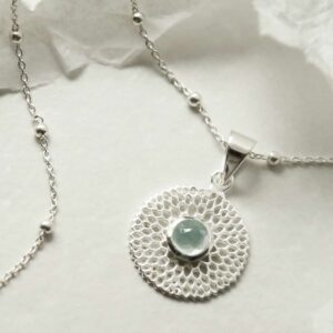 single blue topaz gem in centre of chrysanthemum pendant