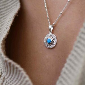 single opalite gem in centre of chrysanthemum pendant on model