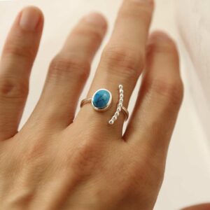 silver adjustable turquoise ring with beaded side on model