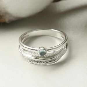 silver blue topaz ring with feather band laid