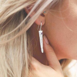 silver water pour earrings with amethyst on model