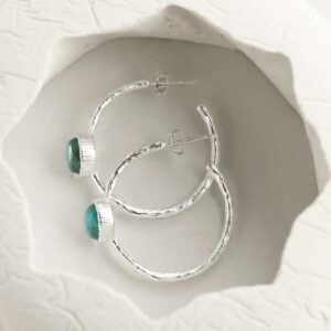 silver textured stud hoops with blue topaz top down