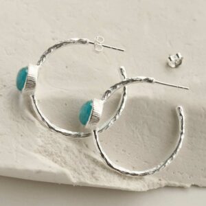 silver textured stud hoops with blue topaz side view