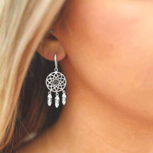 silver dangly dream catcher earrings with centre blue topaz on model