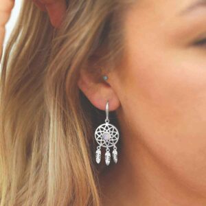 silver dangly dream catcher earrings with centre moonstone on model