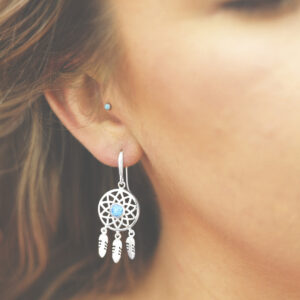 silver dangly dream catcher earrings with centre opalite on model