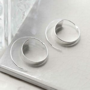 silver gradient curl threader earrings on tile