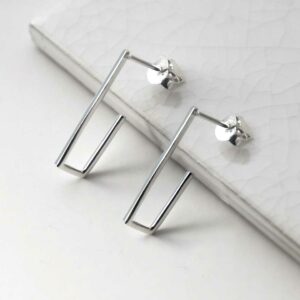 silver staple studs leaning on tile