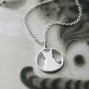 silver cat pendant on plain chain strewn