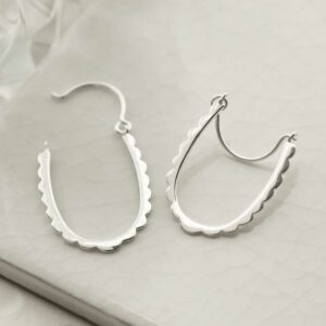 silver bite shape hoops open on tile