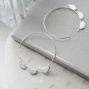 silver three semi circles on hoops leaning on tile