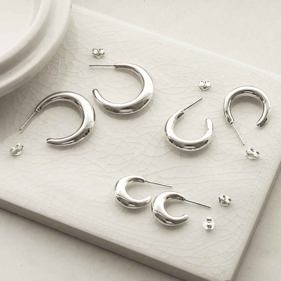 silver all sizes thick hoop studs on tile