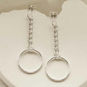 silver hanging hoop on curb chain earrings laid