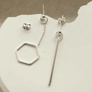 silver hanging hexagon and bar earrings strewn