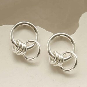 silver rings hanging on hoop stud earrings hanging