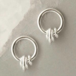 silver rings hanging on hoop stud earrings hanging