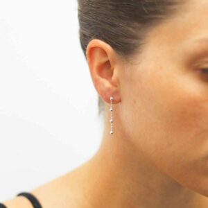 silver ball chain dangly earrings on model