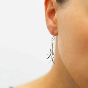 silver spiky dangling leaves earrings on model