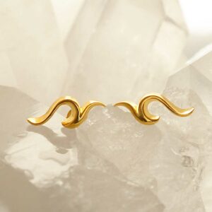 gold flame stud earrings on crystal