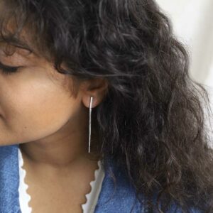 Model wearing double box chain earrings